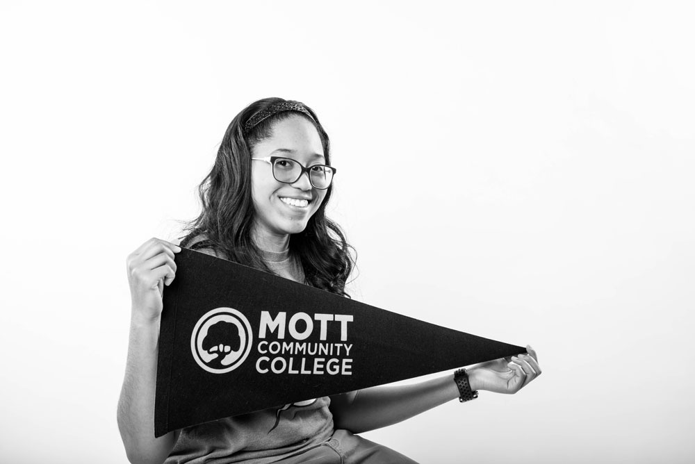 female student holding pennant