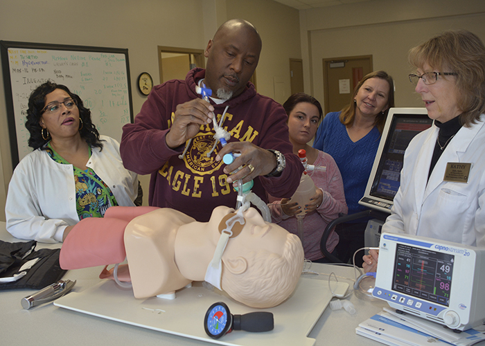 Respiratory students practicing intabation on SIM man