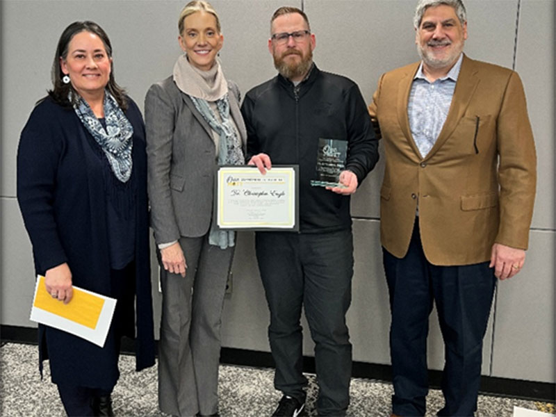 Dr. Christopher Engle holding award