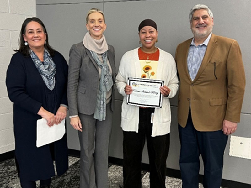 Katrina Ireland-Torrey holding award