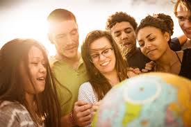 students with hands on globe