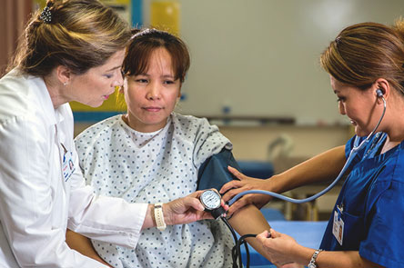 Nursing students taking blood pressure