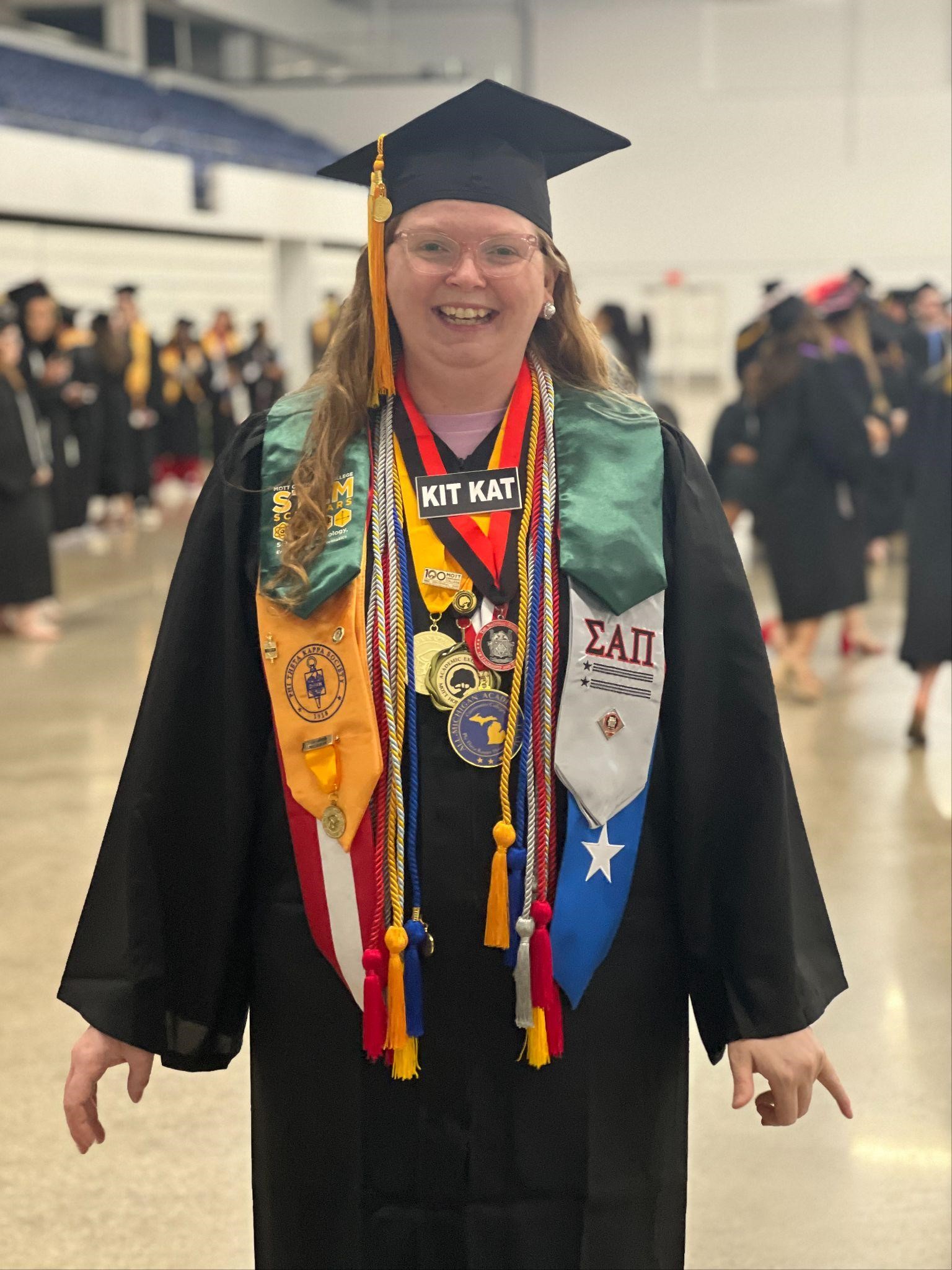 MCC student showing off commencement regalia