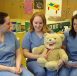 Dental Hygiene students demonstrating how to brush your teeth