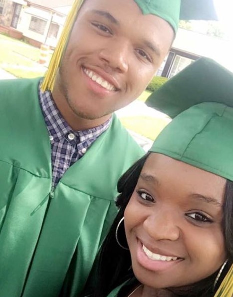 two high school graduates posing for photo