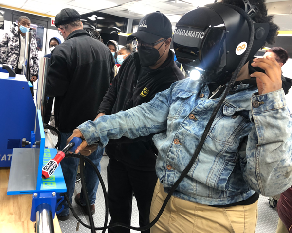 Student participating in welding exercise.